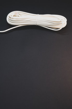A vertical shot of an electrical extension cord isolated on black background