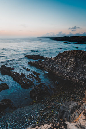 A vertical shot of a beautiful sunset on the beachの写真素材
