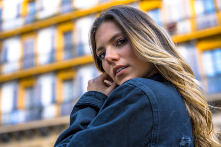 A Latin blonde woman posing in the town square