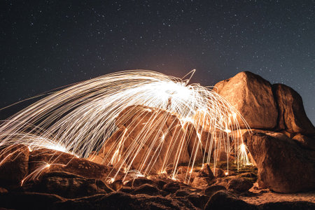 A beautiful steel wool shot of the motion of hot embers flying through the airの写真素材