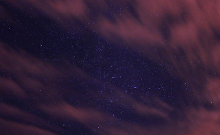 A low angle shot of a starry purple sky
