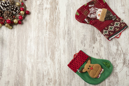 A flat lay of colorful Christmas decorations on a wooden table with a copy spaceの写真素材
