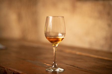 A soft focus of a wineglass with alcoholic beverage  on a barの写真素材