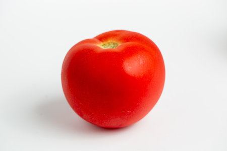A red tomato isolated on a white backgroundの写真素材