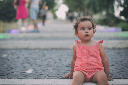 A selective focus shot of an adorable little girl with curly hairの写真素材