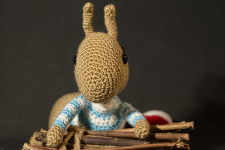 A cute knitted toy bunny with a small bundle of firewood - perfect for easter decorationsの写真素材