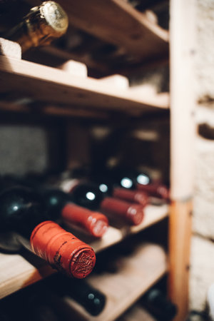 A vertical closeup shot of wines in a wine rackの写真素材