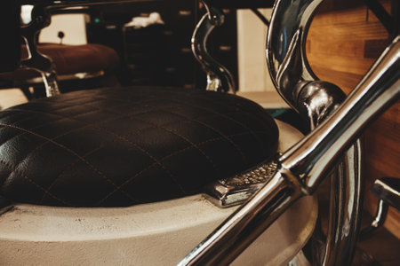 A black hairdresser chair with a metal leverの写真素材