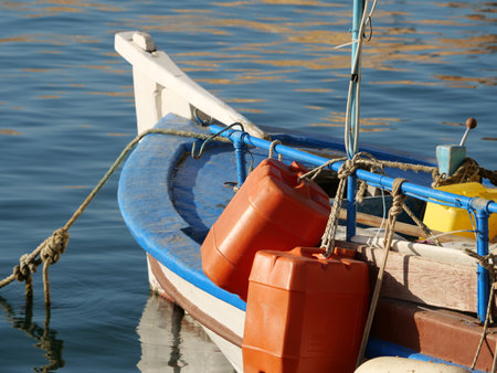 A closeup of two red huge empty plastic barrels attached to the boat in the seaの写真素材