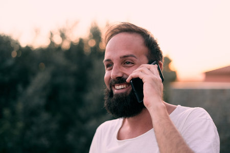 A shallow focus shot of a young caucasian talking on the phone