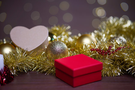 A closeup shot of Christmas decorations on the table with a bokeh background