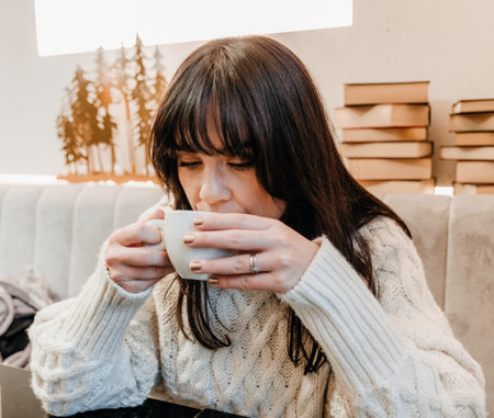 A woman drinking coffee in a cafeの写真素材