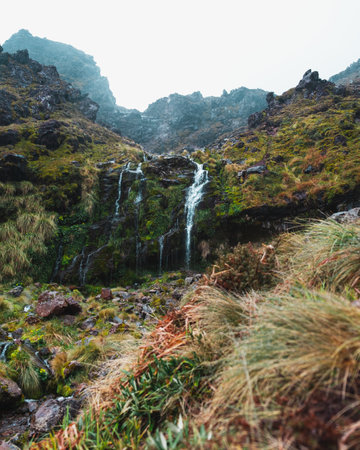 A vertical shot of a waterfall in high mountainsの写真素材