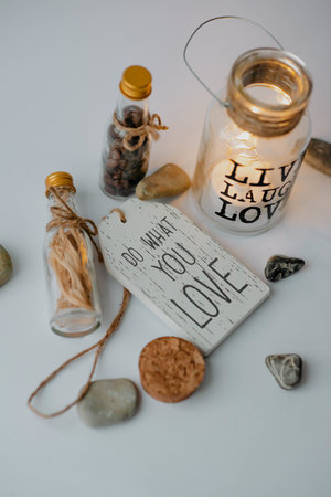 A vertical shot of a jar with the text live laugh love in a decoration setの写真素材