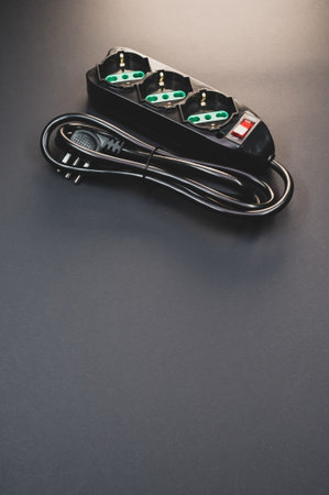 A black surge protector on a black background