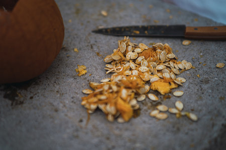 A man carving and preparing a pumpkin for Halloweenの写真素材