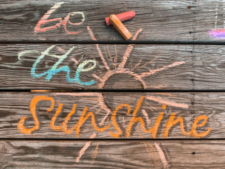 a positive be the sunshine chalk writing on a wooden boardの写真素材