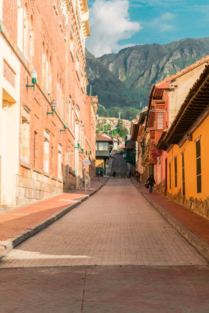 A vertical shot of alleyway with old buildings on the sideの写真素材
