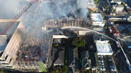 An aerial view of firefighters putting out a fire at an apartment complex in Oakland, Californiaのeditorial素材