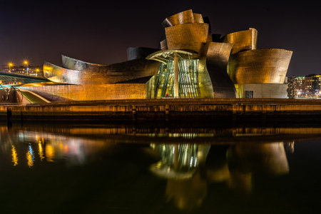 A closeup shot of Guggenheim Museum on Nervion River illuminating at nightのeditorial素材