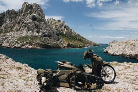 The beautiful scenery of a motorcycle on a background of rocks and a sea in Marseille, Franceのeditorial素材