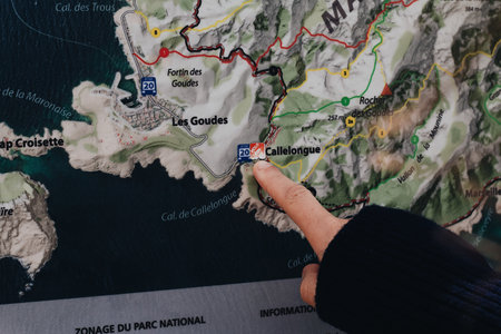 A horizontal shot of a finger pointing at Callelongue on a map, Franceのeditorial素材