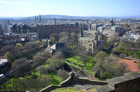 A view of the city from the Edinburgh Castle under the sunlight and a blue sky in Scotlandのeditorial素材