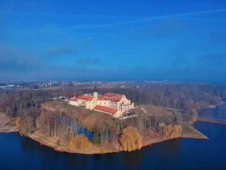 An aerial  shot of a water reservoir near a cityのeditorial素材