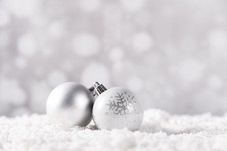A closeup shot of a white Christmas ball on white backgroundの写真素材