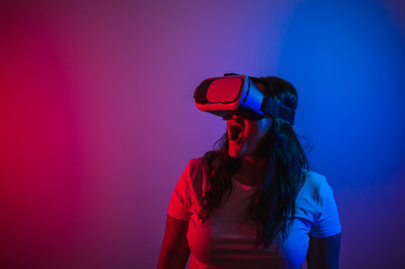 A portrait of a brown girl plus size model with a virtual reality headset goggles, hand gesturesの写真素材