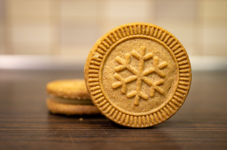 A selective focus shot of delicious ginger cookies with the pattern of a snowflake on themの写真素材