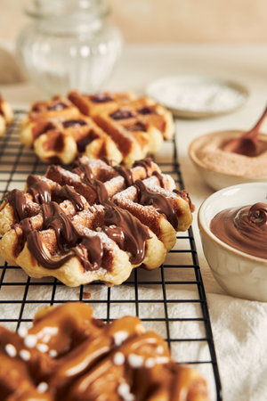 A vertical shot of delicious Waffles with chocolate dip on a white tableの写真素材