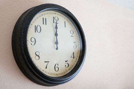 A wall clock marking twelve o'clock on New Year's Eve
