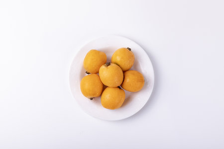 Fresh loquat fruits isolated on a white backgroundの写真素材