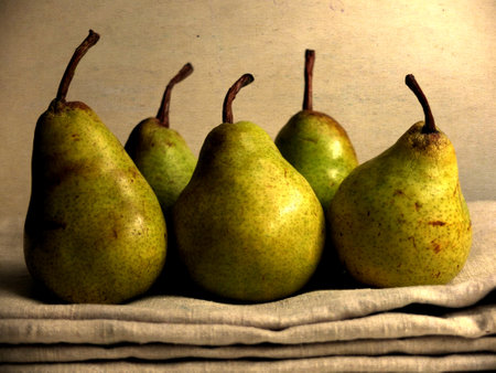 A closeup shot of fresh pears on a light brown backgroundの写真素材
