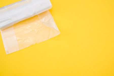 A top view of the plastic bags on a yellow surface - space for textの写真素材