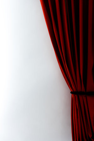 A vertical shot of red curtains with a white wallの写真素材