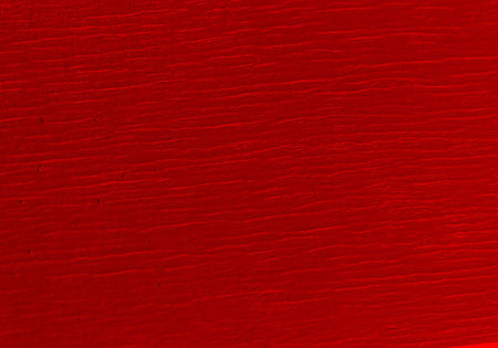A closeup of red, vintage pattern background on rustic wooden parquet planks
