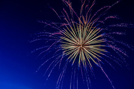 A low angle shot of colorful fireworks with long exposure at nightの写真素材
