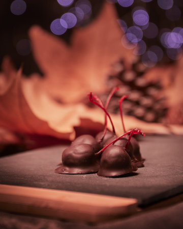 A closeup shot of chocolate-covered cherries with bokeh backgroundの写真素材