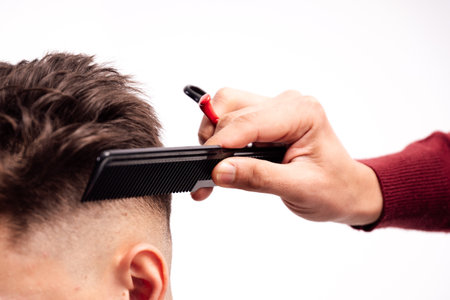 A closeup shot of barber combing client's hair