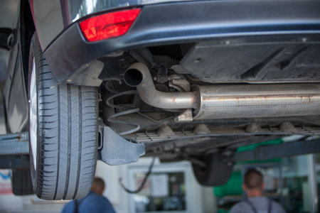 A closeup shot of a car parked in an automobile repair shop for an inspectionの写真素材