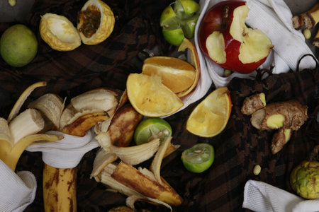 A top view of half-eaten fruits and vegetables on a table - wasting foodの写真素材