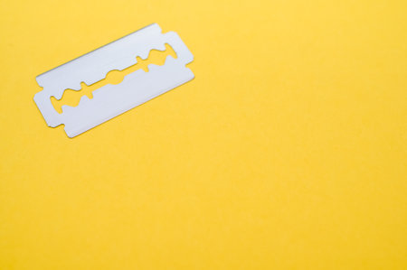 A high angle shot of blade isolated on yellow background