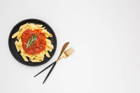 A closeup of a plate of pasta on a white backgroundの写真素材