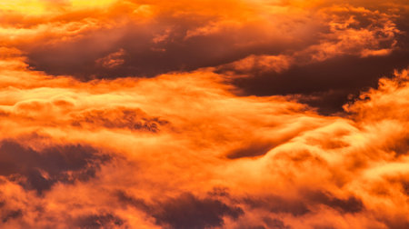 The cloudy orange sky during sunset perfect for backgroundの写真素材