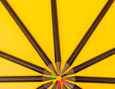Group of colored pencils on a yellow backgroundの写真素材