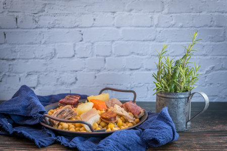 A view of Madrid stew and rosemary on rustic backgroundの写真素材