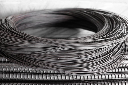 A pile of steel round rods storage and stacking in a warehouse for an industrial buildingの写真素材