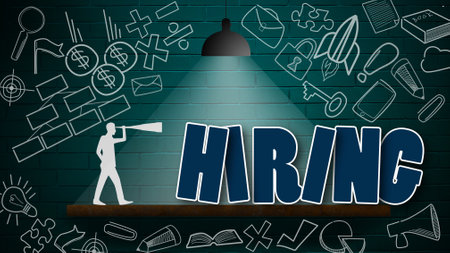 A word 'hiring' under a lamp against a brick wall - recruitment conceptの写真素材